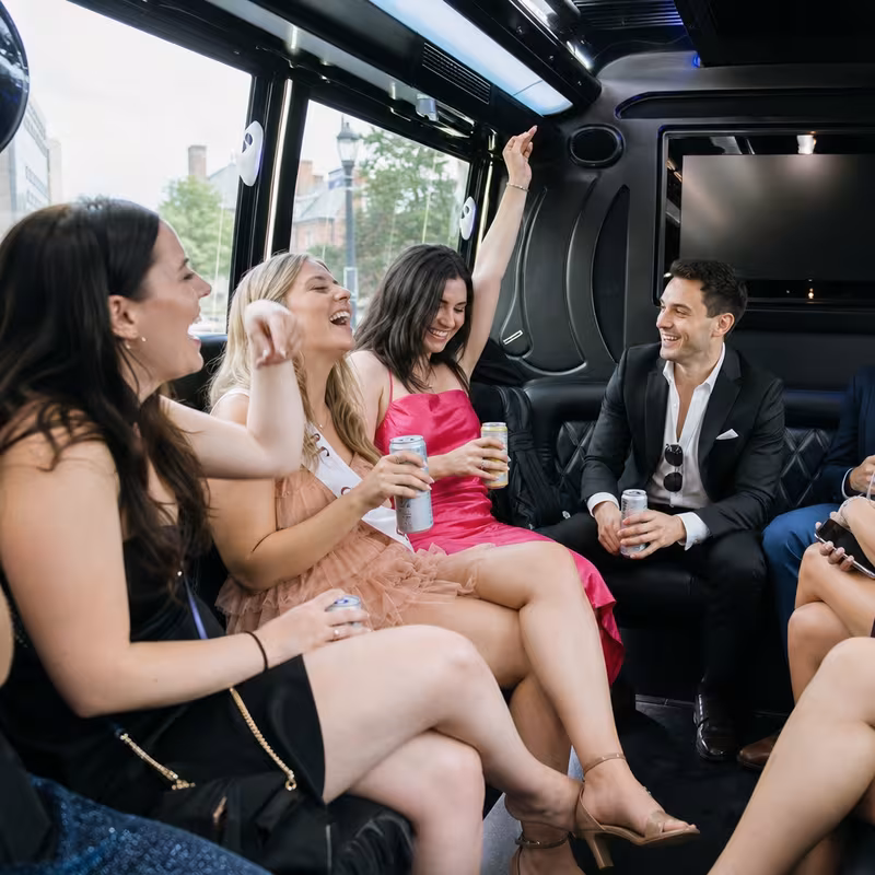Party bus interior with wraparound leather seating and LED lighting in Princeton