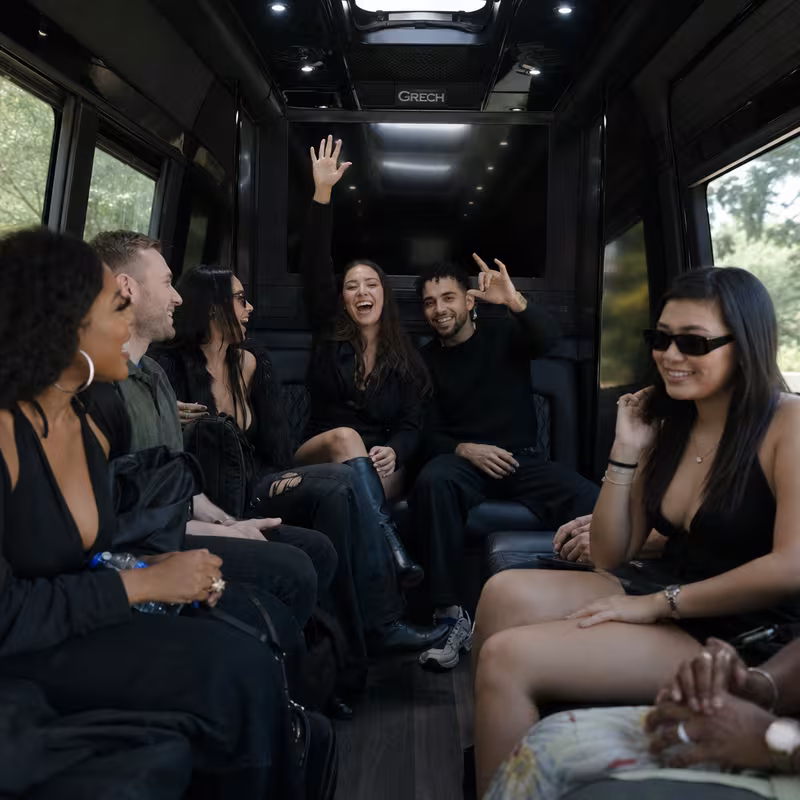 Group boarding a white charter bus for Concert Transportation transportation in Princeton