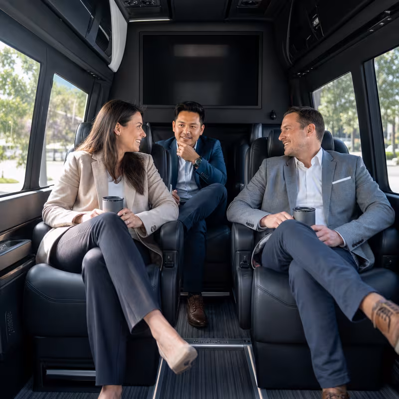 Group boarding a white charter bus for Corporate Transportation transportation in Princeton