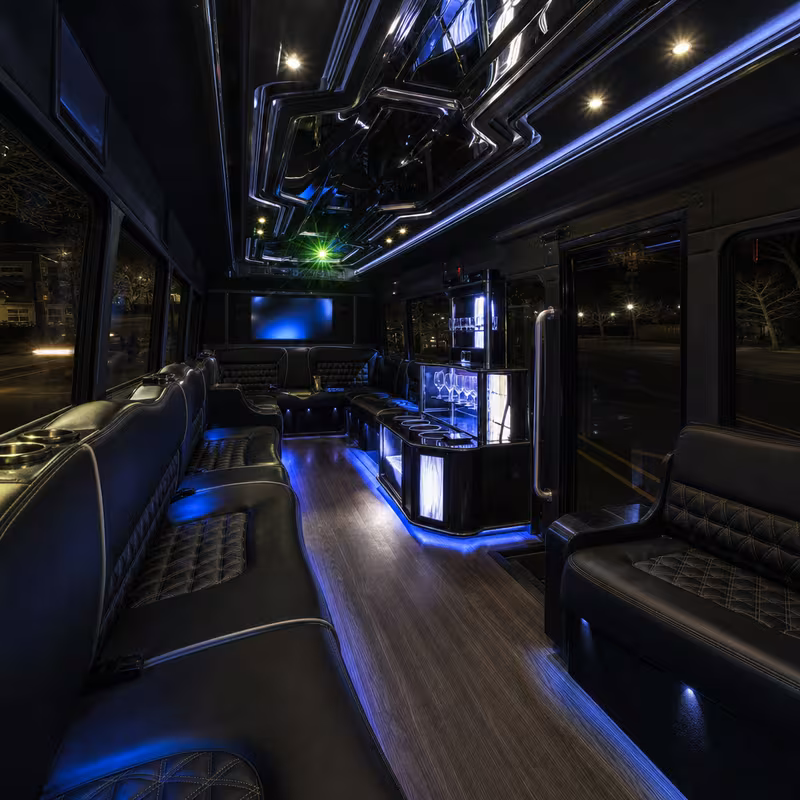 Party bus interior with wraparound leather seating and LED lighting in Princeton