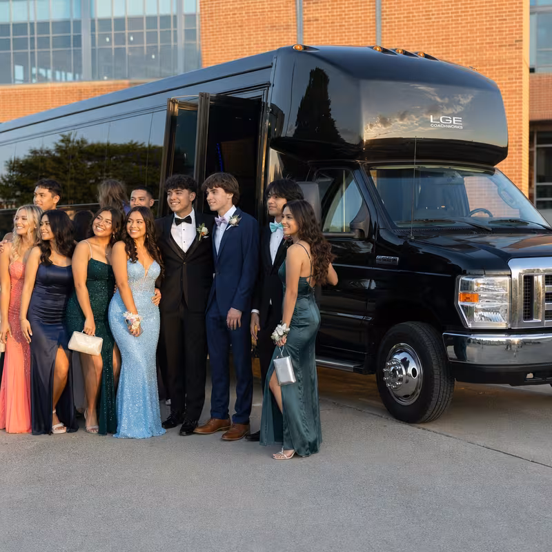 Group boarding a white charter bus for Prom & Homecoming Transportation transportation in Princeton