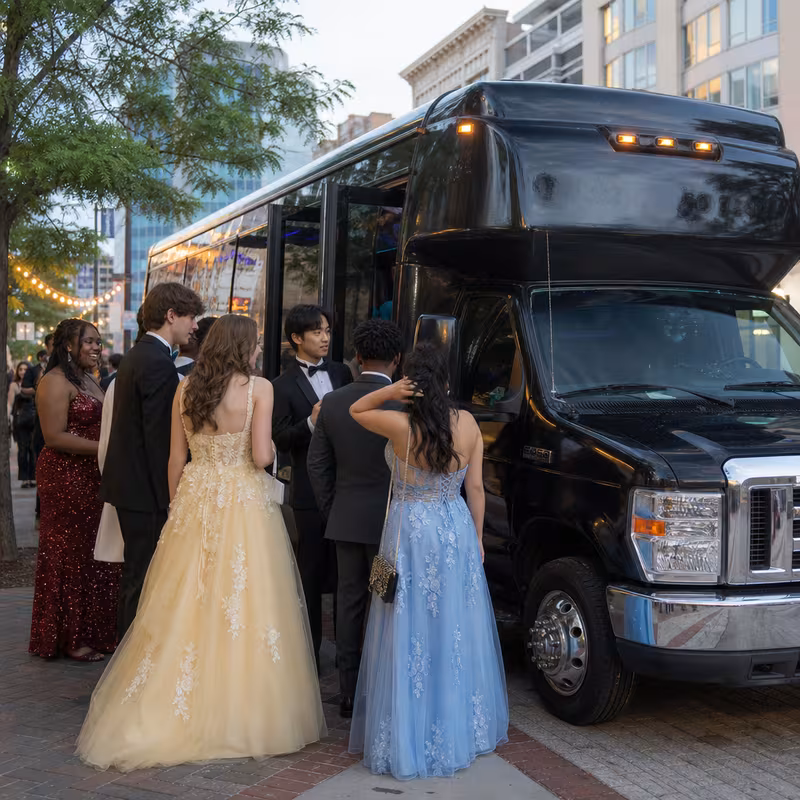 Passengers loading luggage while boarding an Princeton group shuttle