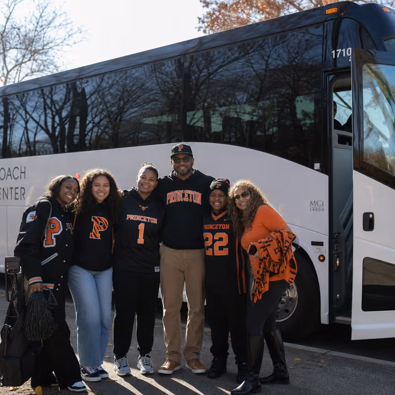 Passengers loading luggage while boarding an Princeton group shuttle