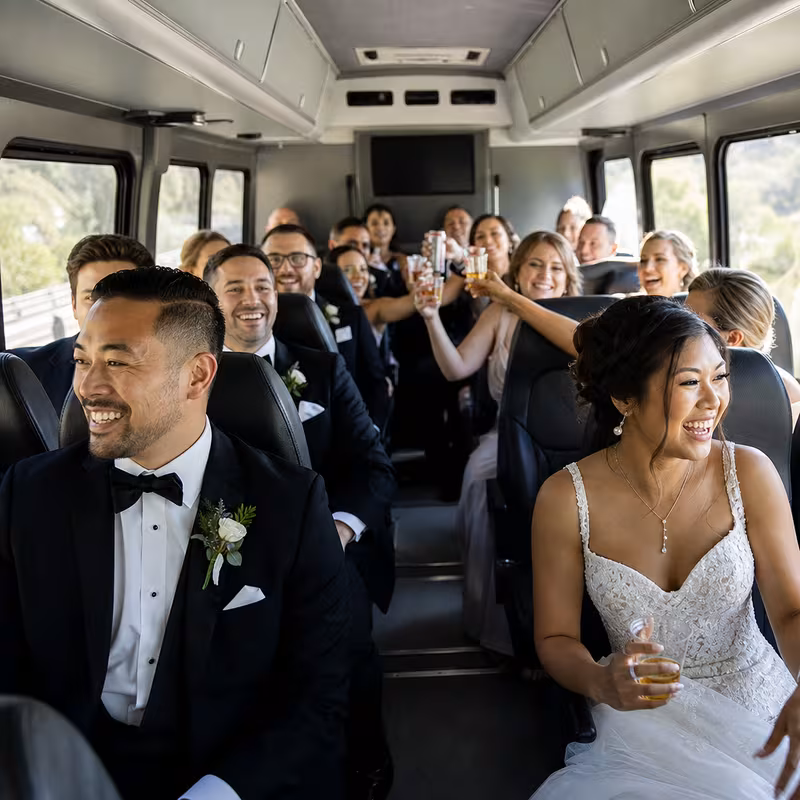 Group boarding a white charter bus for Wedding Transportation transportation in Princeton