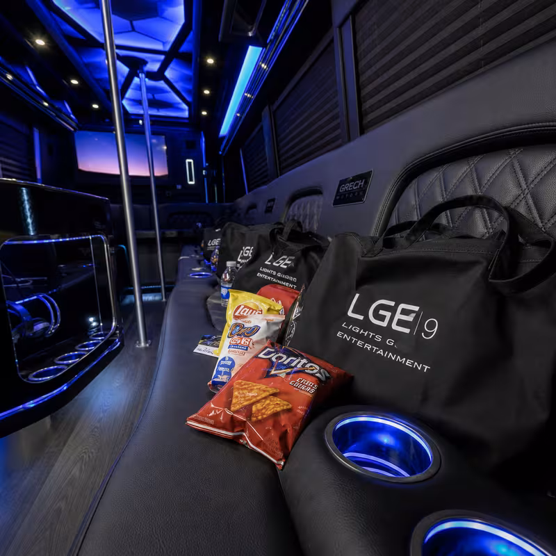 Party bus interior with wraparound leather seating and LED lighting in Princeton